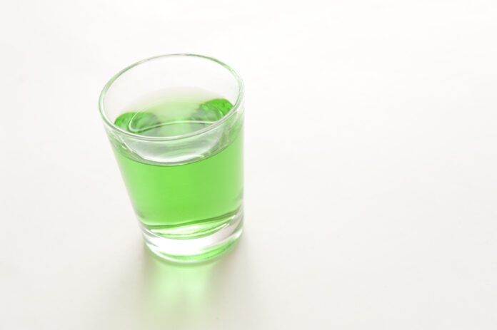 Glass of green absinthe liqueur